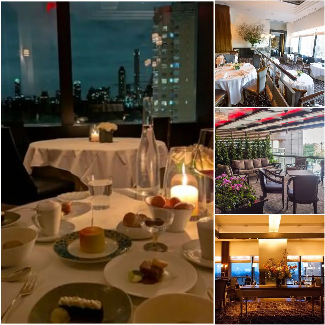 Interior dining area of Per Se restaurant in New York City with elegant seating and views outside through large windows